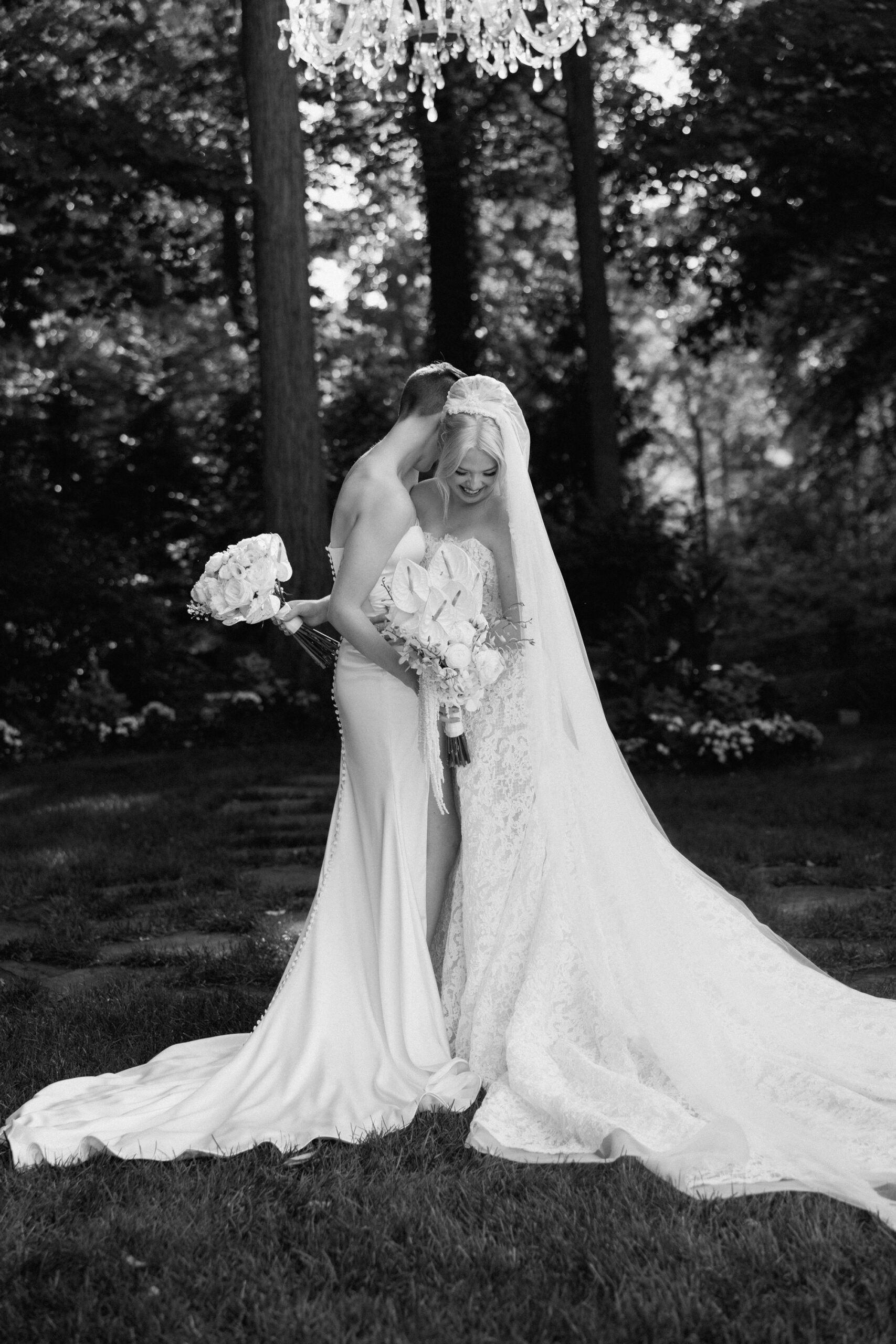 Two brides embrace at their wedding